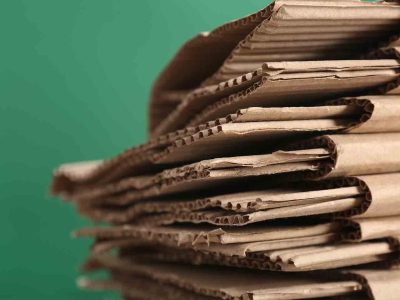 cardboard-pile-on-color-background